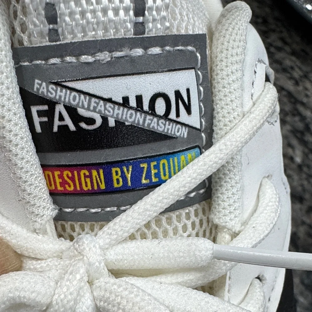 White and Black womens fashion Sneakers with gold accents EUC 10